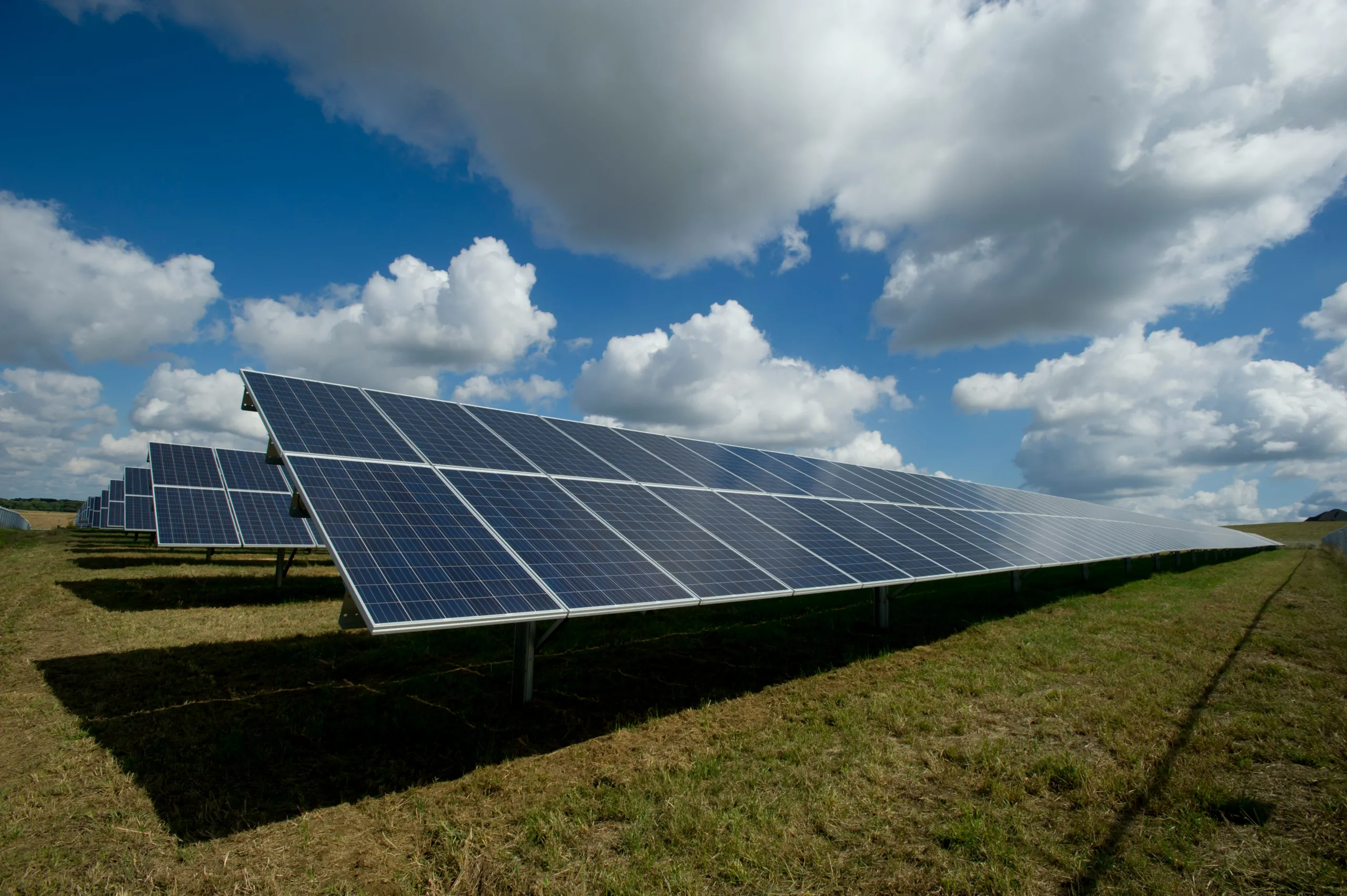 NIS2 solar energy compliance — large-scale solar farm with grid infrastructure